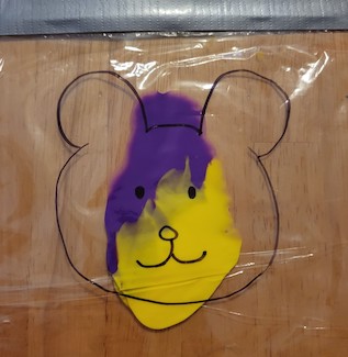 Yellow and purple paint in a bag